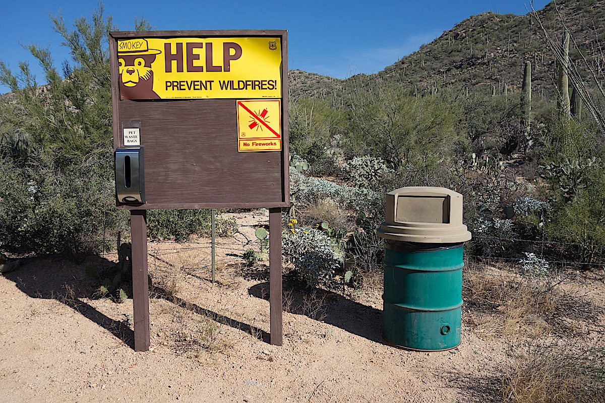 Signs and trashcan at the start of the trail. December 2014.