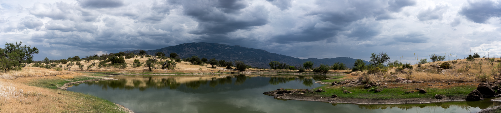 White Tank off Redington Road near the Bellota Trail - Rincons in the distance, storm clouds above. June 2016.