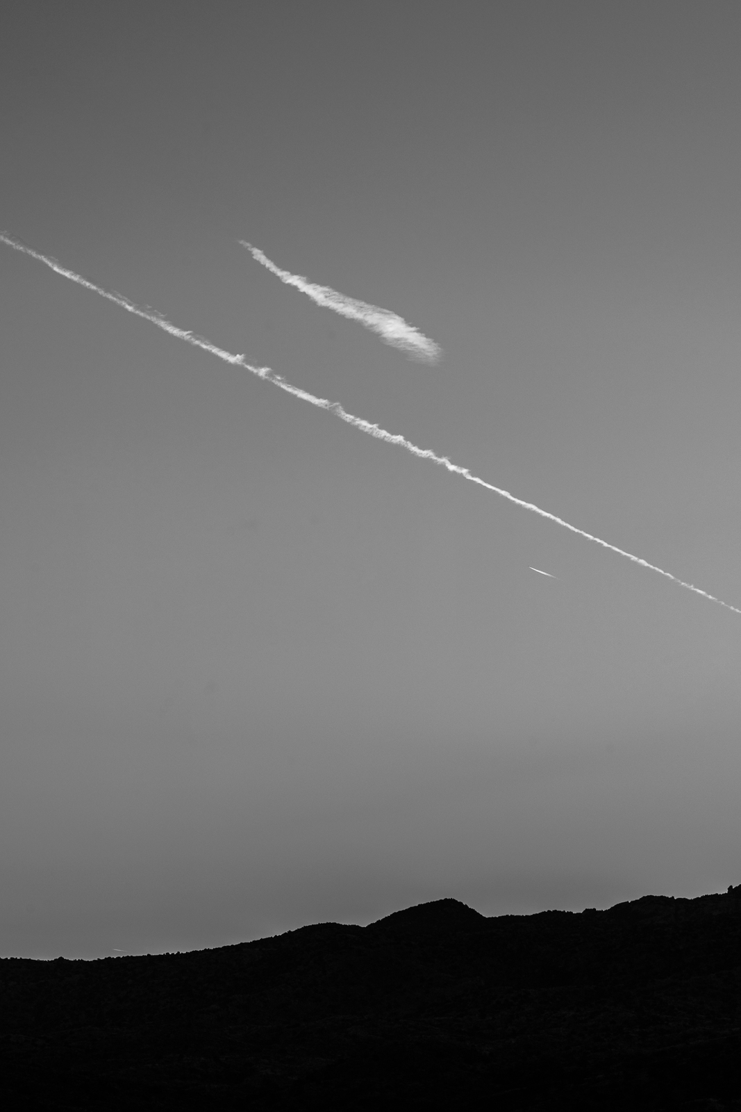 Cloud streaks over the edge of the Rincon Mountains from Redington Road, near sunrise. October 2016.