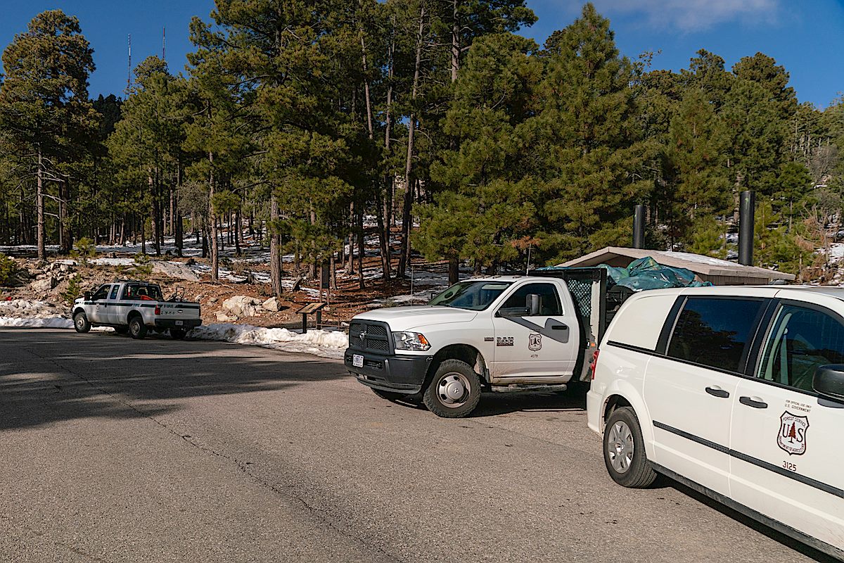 Three Forest Service workers were out cleaning up - barely visible but you they had nearly filled the larger truck and were loading trash into the smaller truck too. January 2019.