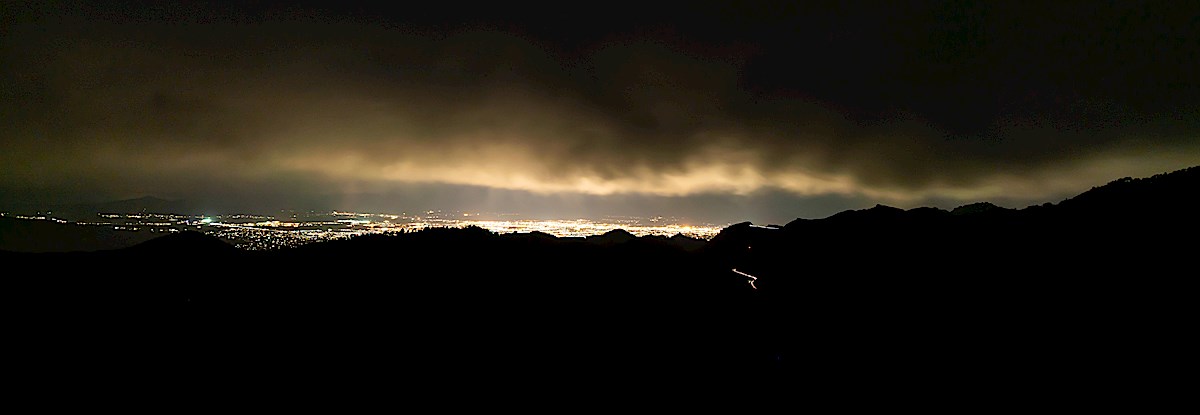 Clouds, city and headlights on the highway from Guthrie Mountain. May 2019.