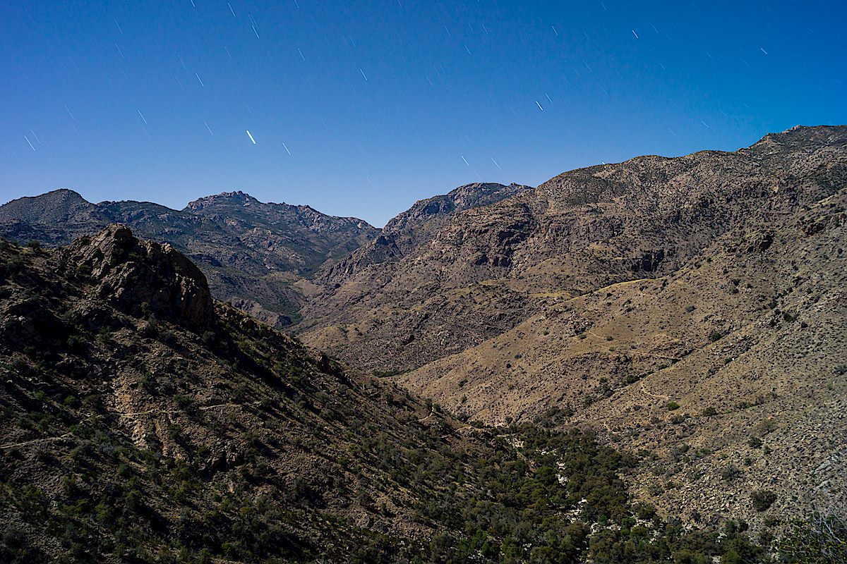 Night in the Santa Catalina Mountains - you can just make out the Palisade Trail making it's way down the hillside to it's junction with the East Fork Trail (visible on the left descending in shadow). April 2014.