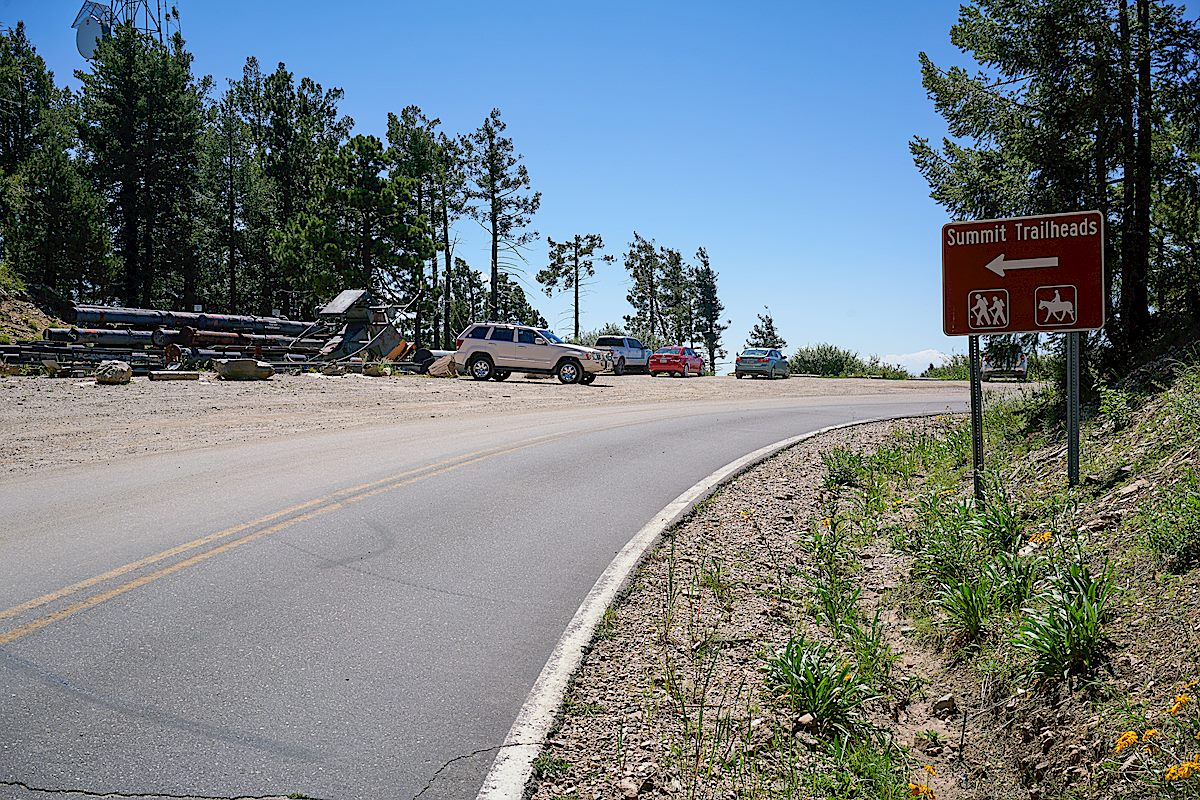 The Summit Trailhead parking is the gravel area on the left. August 2017.